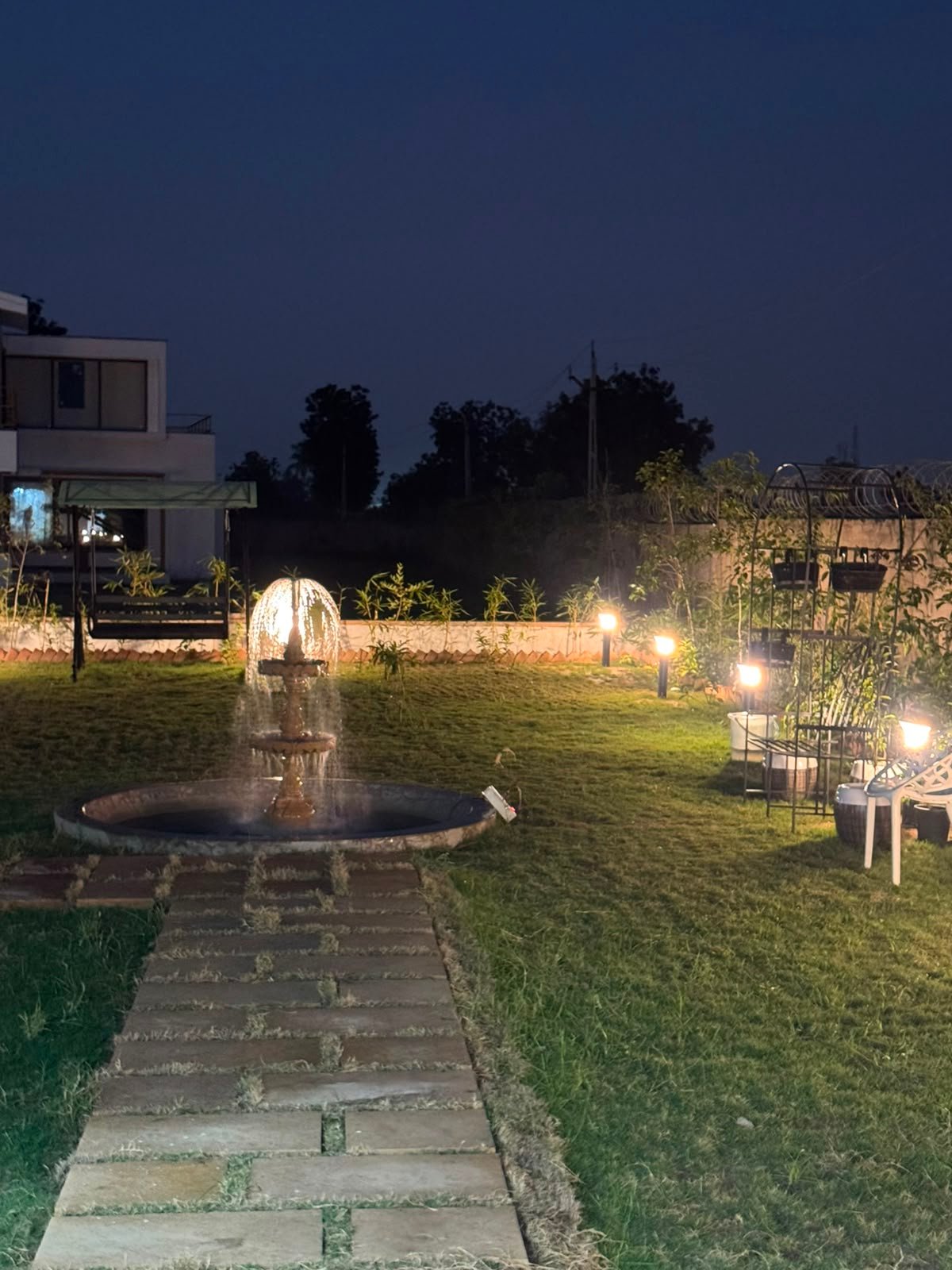 Garden fountain and path at night